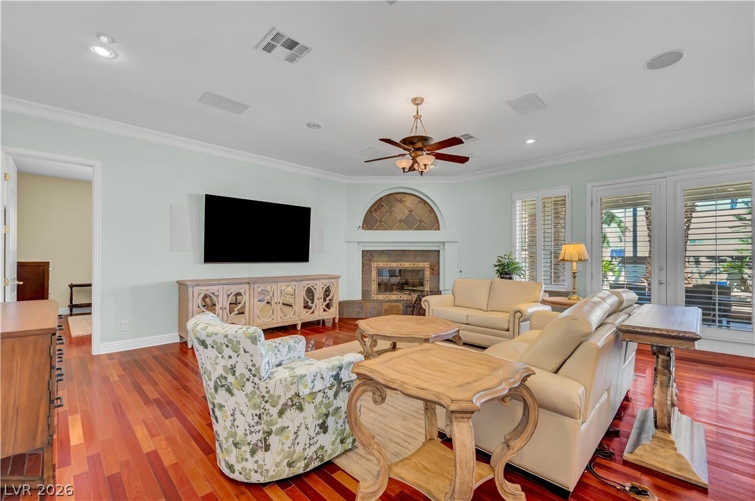 2030 Marina Bay Court, Las Vegas, NV 89117 Rich hardwood floors and a tile fireplace anchor this welcoming living area.