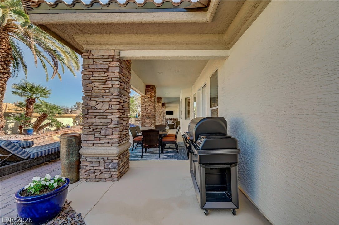 2030 Marina Bay Court, Las Vegas, NV 89117 Sheltered outdoor living is defined by stucco walls, stone columns, and tile roofing.