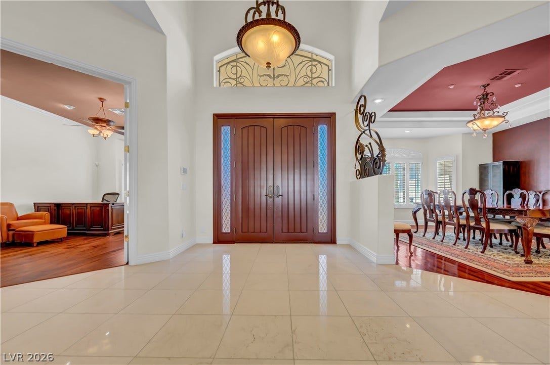 2030 Marina Bay Court, Las Vegas, NV 89117 Double entry doors open into a grand foyer featuring polished tile floors and towering ceilings.