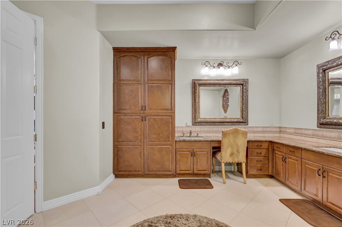 2030 Marina Bay Court, Las Vegas, NV 89117 Rich wood cabinetry and tile flooring elevate this spacious vanity area.