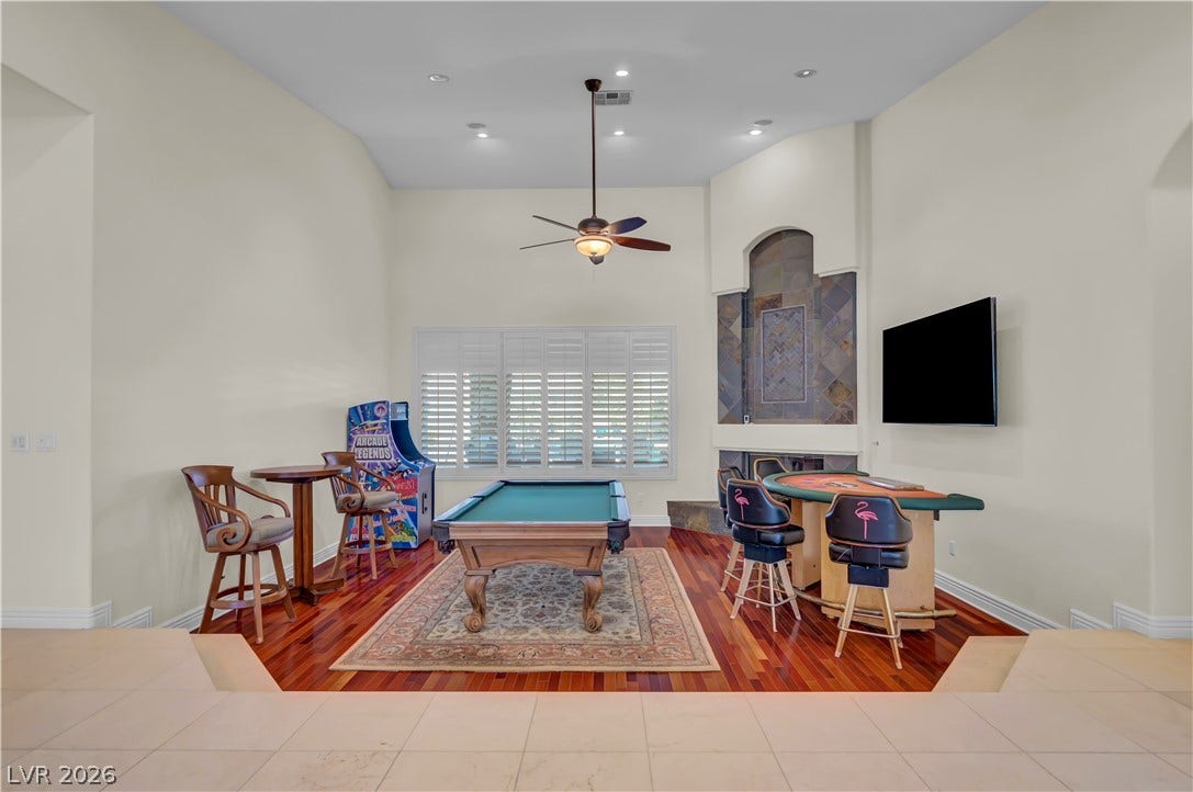 2030 Marina Bay Court, Las Vegas, NV 89117 Rich hardwood flooring complements soaring ceilings and a stone fireplace in this versatile recreational room.
