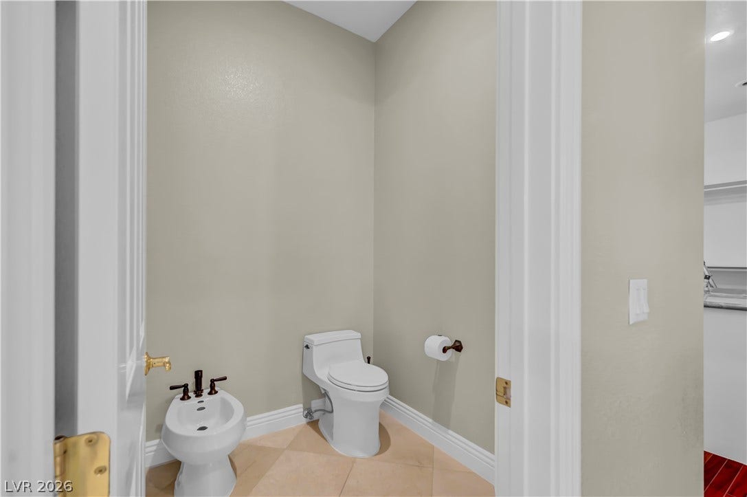 2030 Marina Bay Court, Las Vegas, NV 89117 Tiled flooring and high ceilings define this private water closet featuring an integrated bidet.