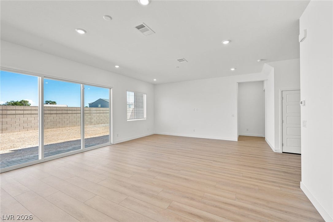 Sliding glass doors open to the backyard from this light-filled living area.