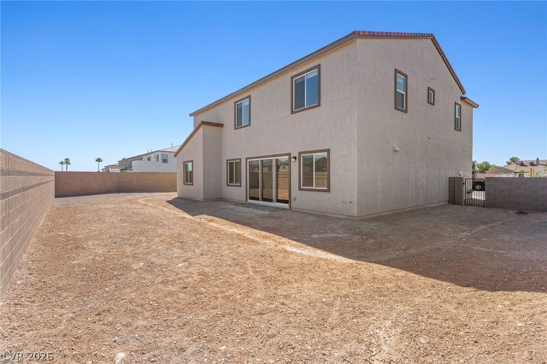 An expansive backyard space enclosed by block walls awaits personalized landscaping design.