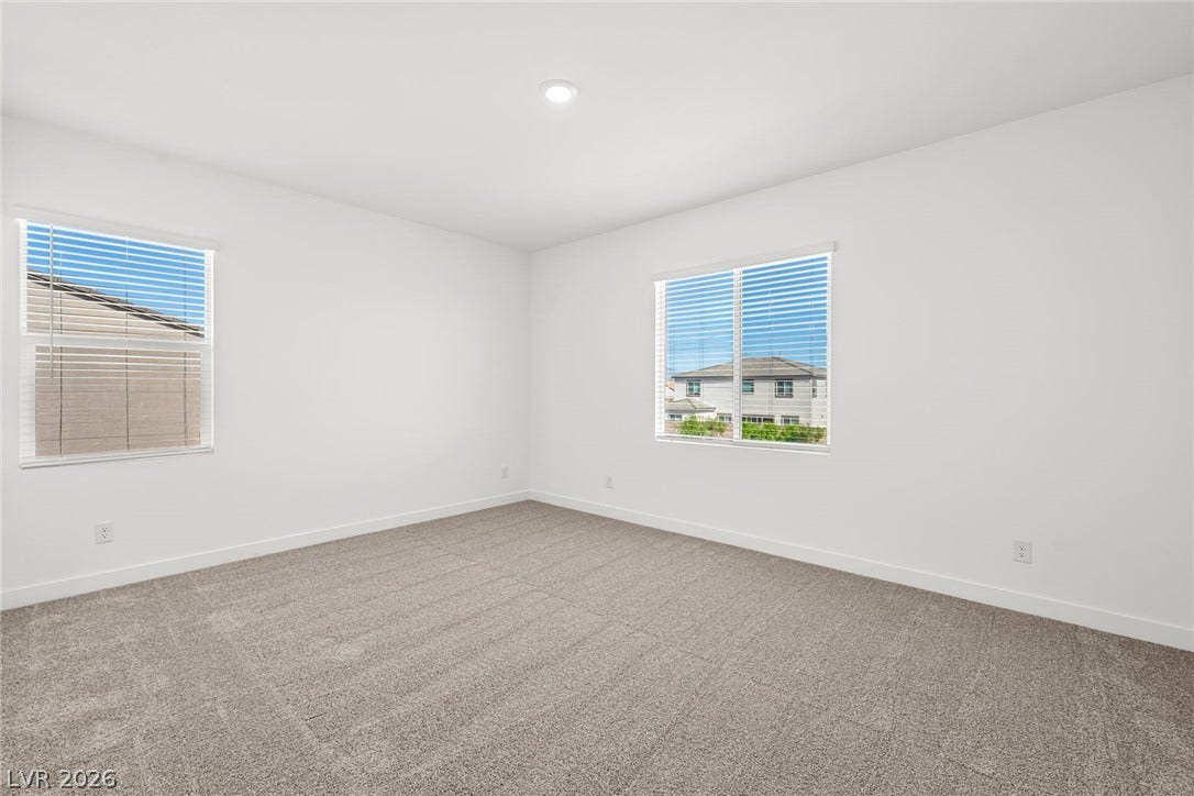 Plush carpeting and dual windows overlooking the neighborhood define this versatile secondary bedroom.