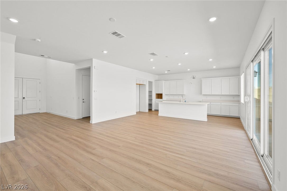 An open floorplan design seamlessly connects the main living space to the kitchen.