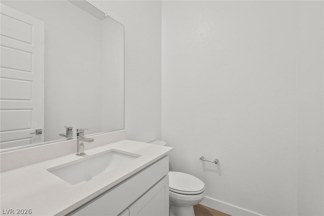 Clean lines and a minimalist vanity define this modern powder room.