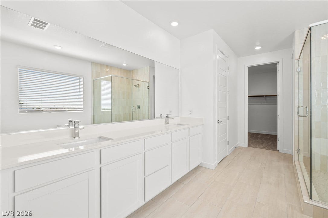 Clean lines and a spacious dual vanity define this modern primary bath sanctuary.
