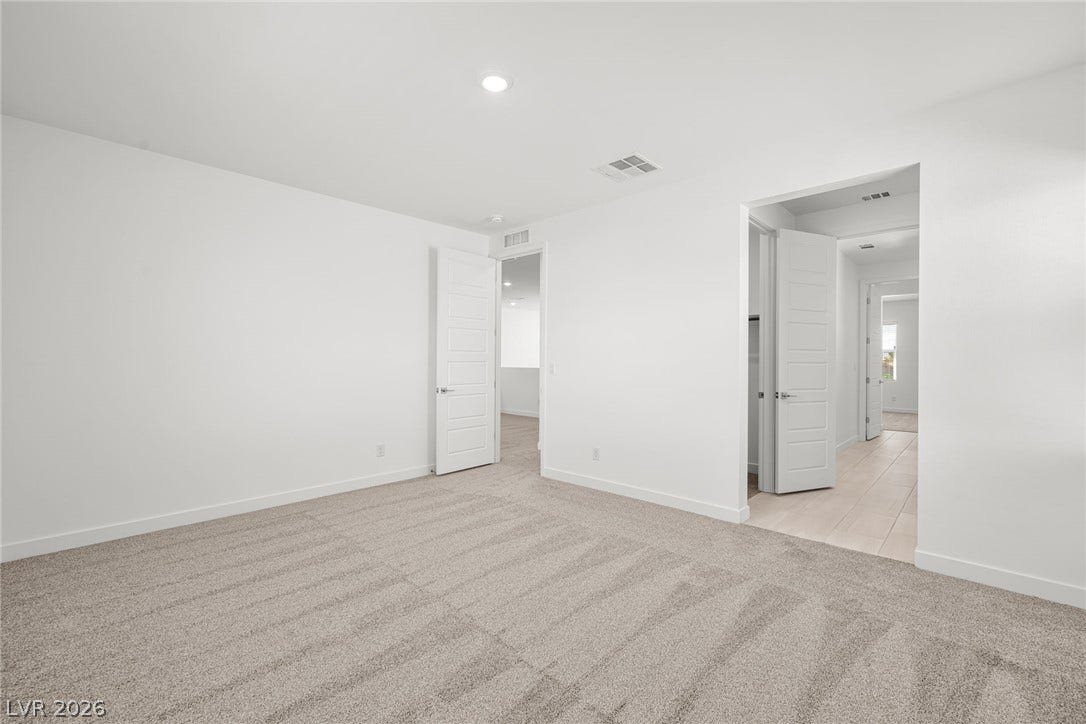 Plush wall-to-wall carpeting and clean lines define this versatile secondary bedroom space.