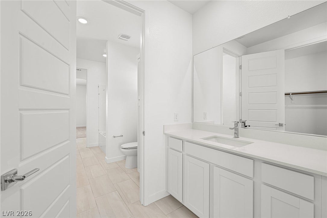 Clean lines and stone counters highlight this modern vanity area.
