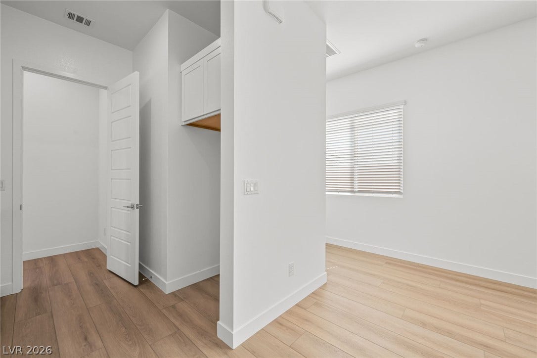 Smooth wood floors and crisp white trim create a clean modern entry.