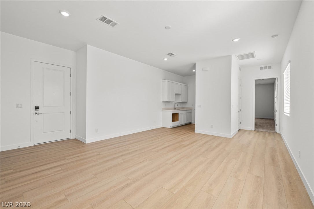 Gleaming wood floors and crisp white walls define this open interior space.