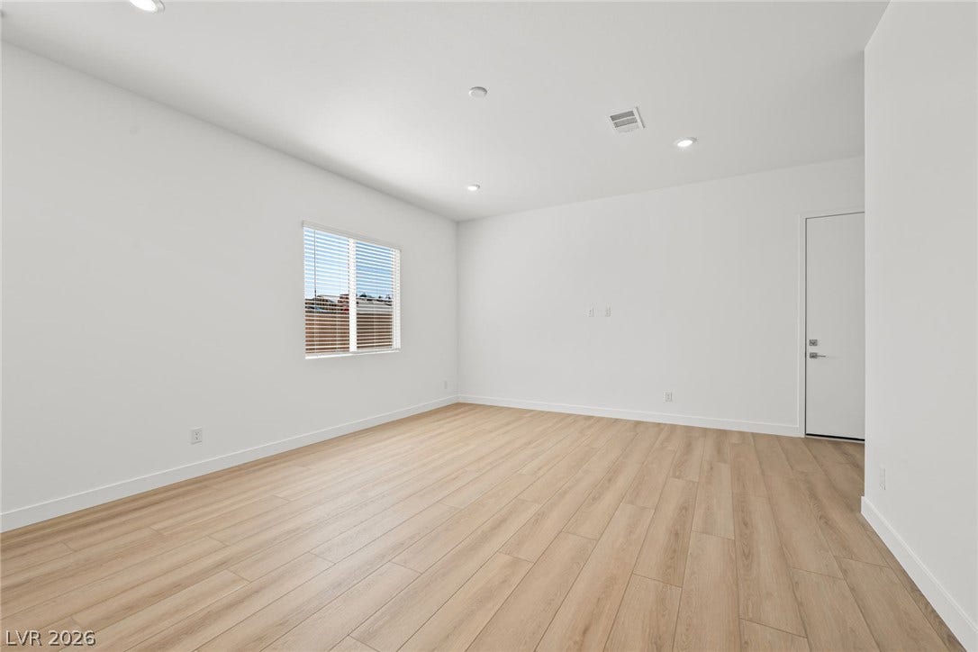 Smooth plaster walls and light oak floors define this serene, open interior space.