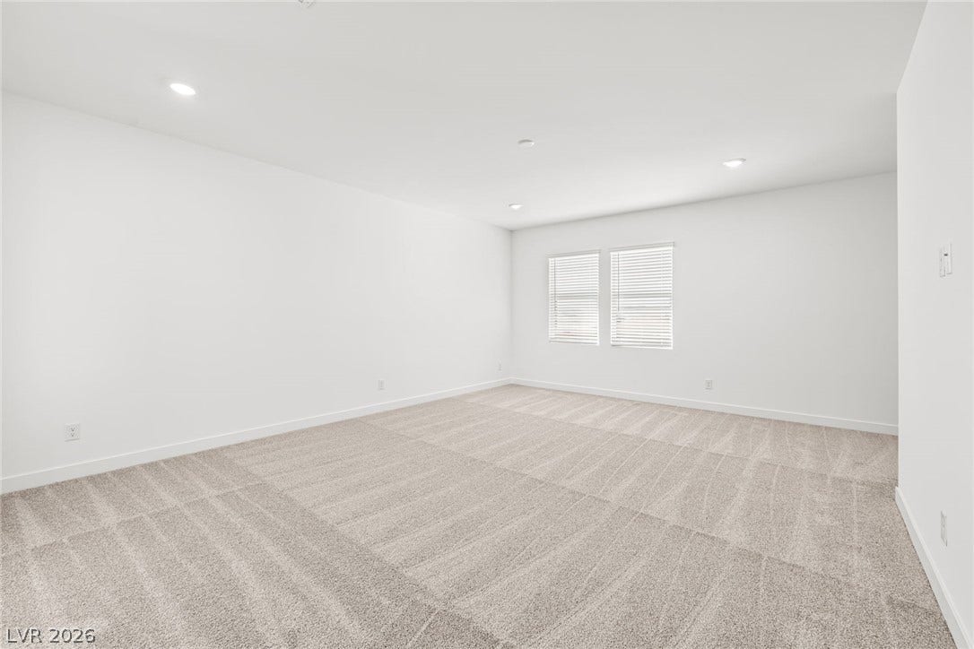 Recessed lighting and soft carpeting create a comfortable atmosphere in this versatile space.