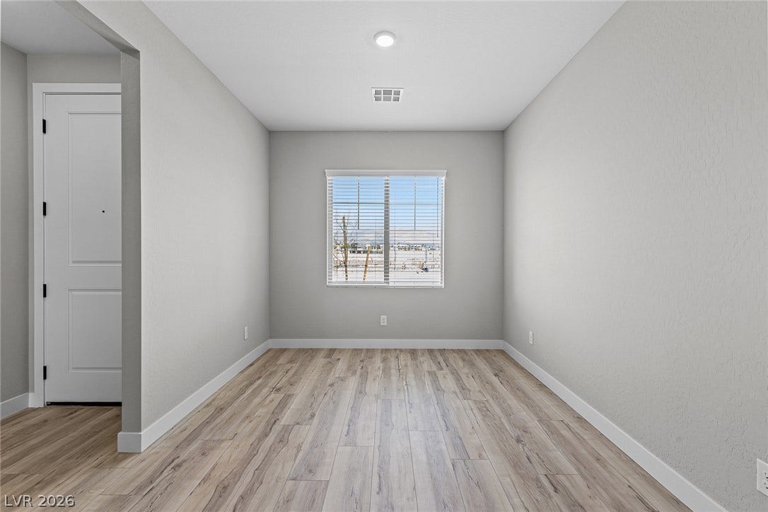 4460 Cave Lake Avenue, North Las Vegas, NV 89032 A window overlooks the outdoor scenery in this versatile space featuring durable wood-look flooring.
