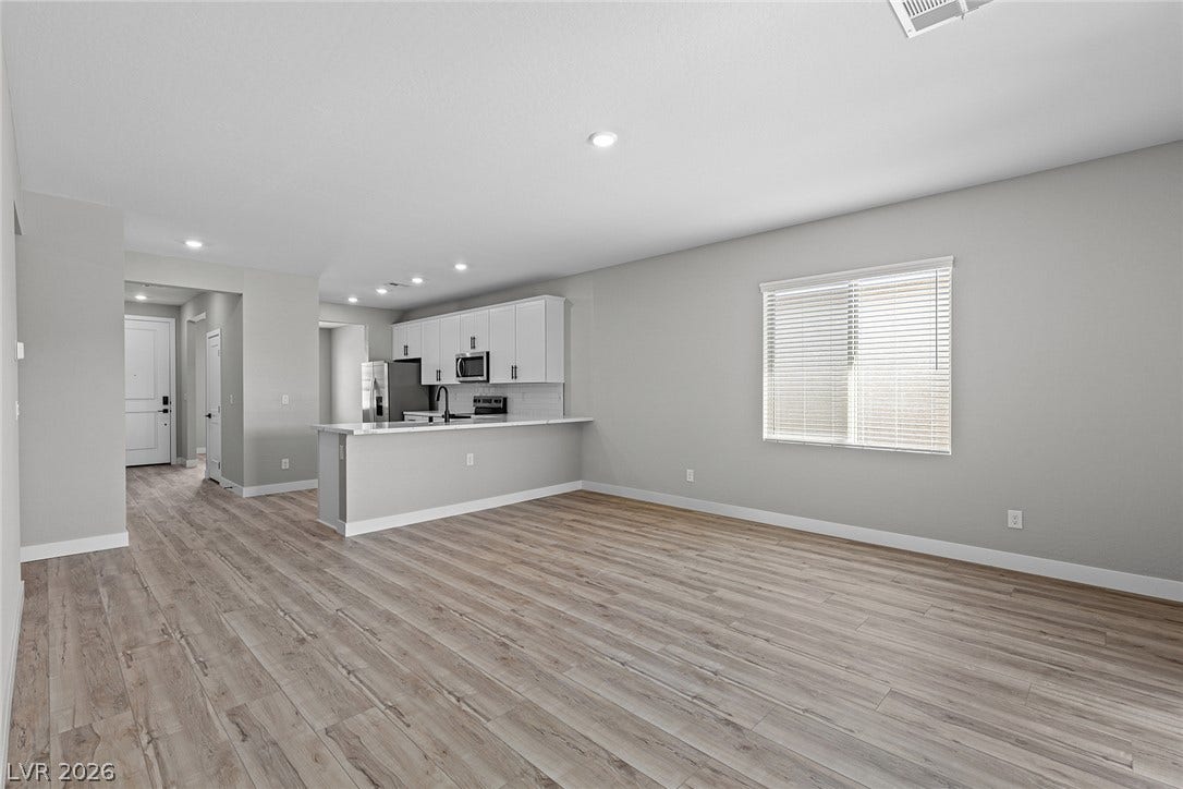 4460 Cave Lake Avenue, North Las Vegas, NV 89032 An open floorplan seamlessly connects the airy living area to the kitchen.