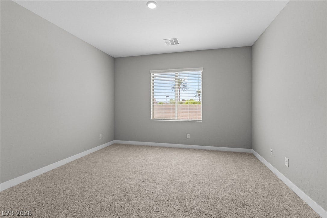 4460 Cave Lake Avenue, North Las Vegas, NV 89032 Plush carpeting and a wide window create a comfortable, inviting secondary bedroom.