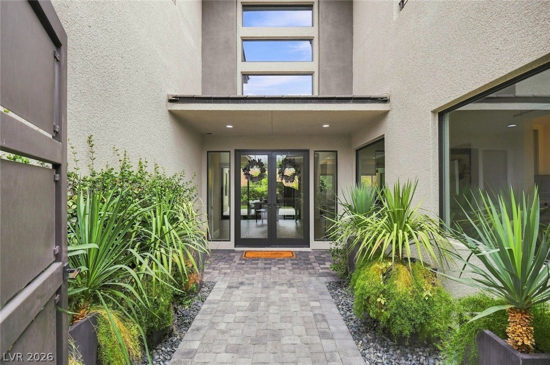1 Moonfire Drive, Las Vegas, NV 89135 An inviting stone-paver walkway leads to the glass double doors of this modern entry.