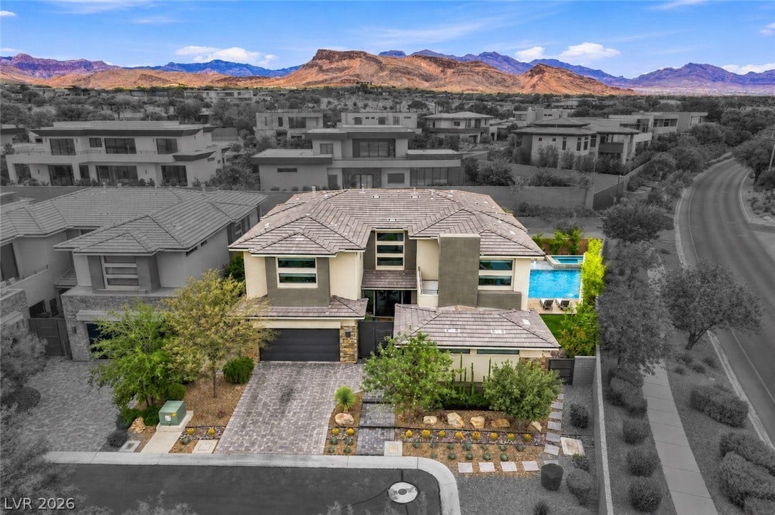 1 Moonfire Drive, Las Vegas, NV 89135 Dramatic mountain vistas rise behind this multi-level home featuring an elegant tiled roof.