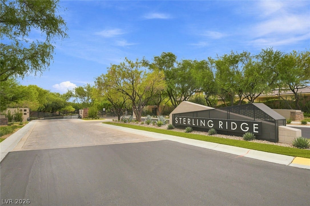 1 Moonfire Drive, Las Vegas, NV 89135 An inviting gated entrance welcomes residents with mature landscaping and clear neighborhood signage.