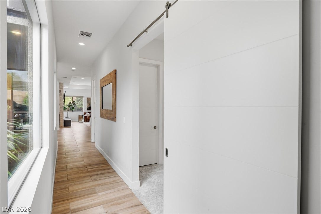 1 Moonfire Drive, Las Vegas, NV 89135 Smooth wood-look tile flooring and clean lines define this modern hallway.