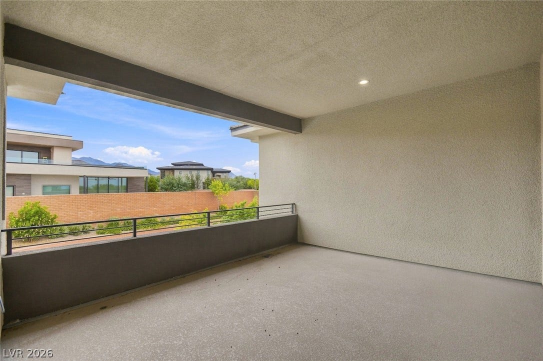 1 Moonfire Drive, Las Vegas, NV 89135 Sheltered outdoor living space frames neighborhood views from a covered balcony.