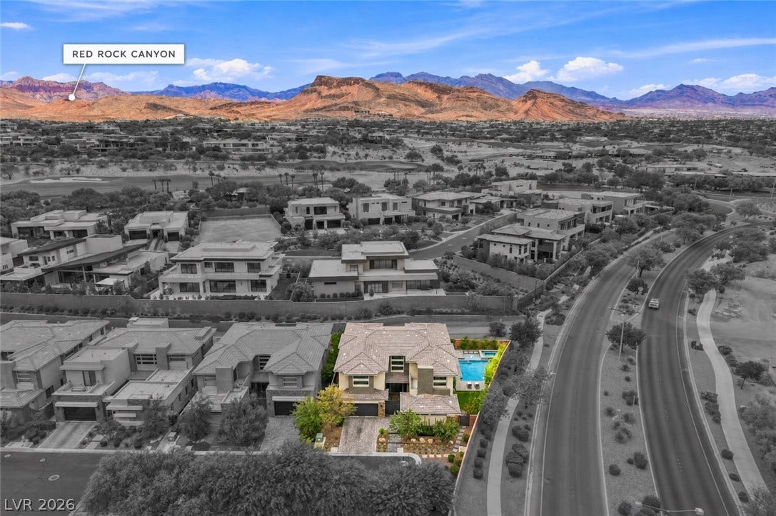 1 Moonfire Drive, Las Vegas, NV 89135 Panoramic mountain ridges frame this desert community featuring a tile-roofed residence with a backyard pool.