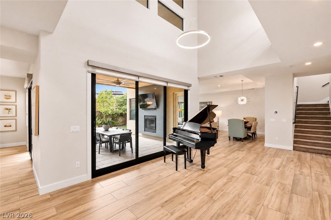 1 Moonfire Drive, Las Vegas, NV 89135 Double-height ceilings and wood-look flooring anchor this airy open-concept living space.