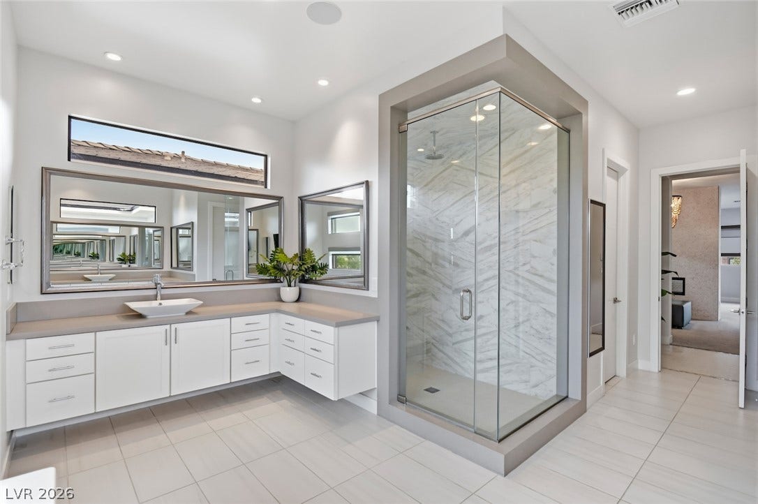 1 Moonfire Drive, Las Vegas, NV 89135 Clean lines and a spacious tiled shower define this modern primary bathroom suite.
