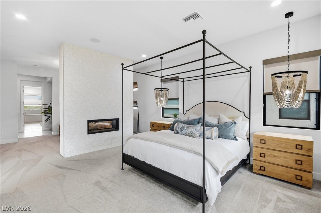 1 Moonfire Drive, Las Vegas, NV 89135 Plush carpeting and a sleek modern fireplace define this serene main suite sanctuary.