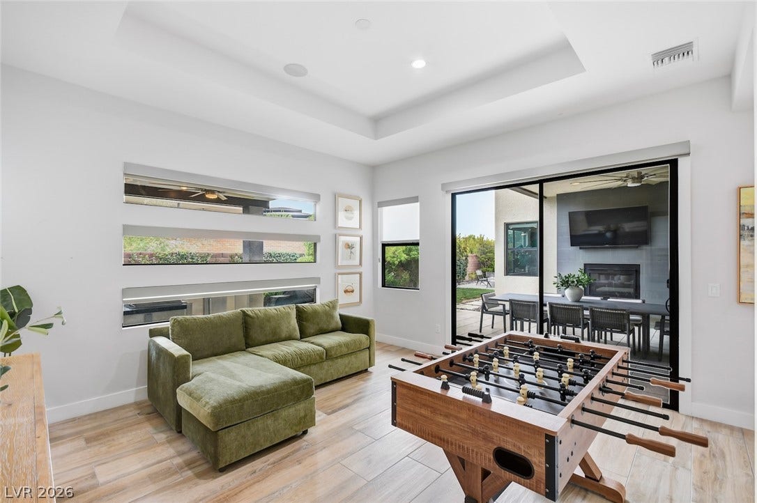 1 Moonfire Drive, Las Vegas, NV 89135 Recessed ceilings and sliding glass doors highlight this modern multi-purpose recreation room.