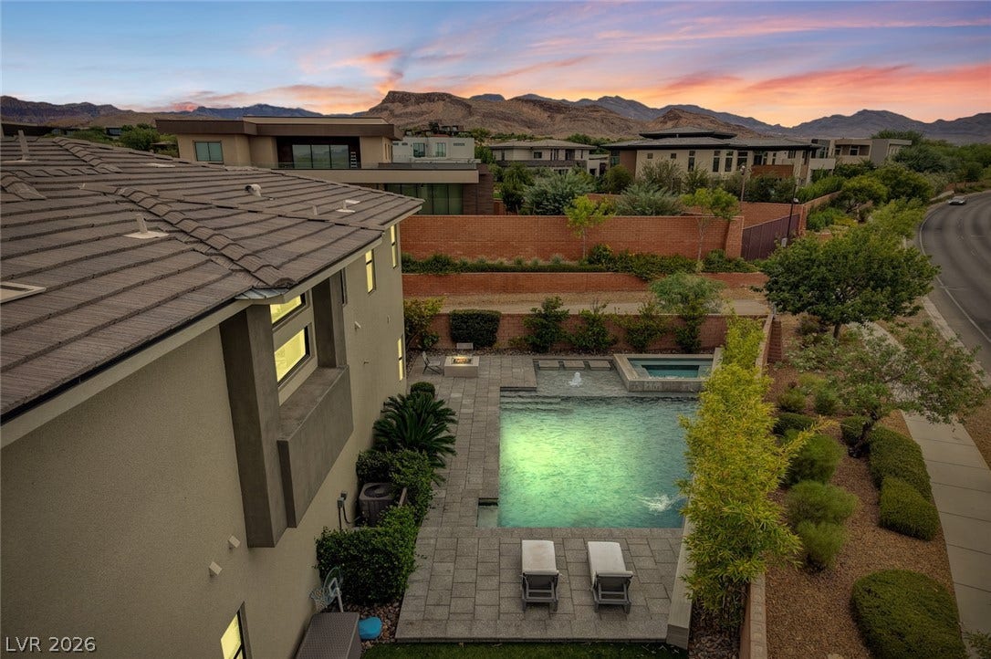 1 Moonfire Drive, Las Vegas, NV 89135 Dramatic mountain backdrops frame this private backyard oasis complete with a pool and integrated spa.