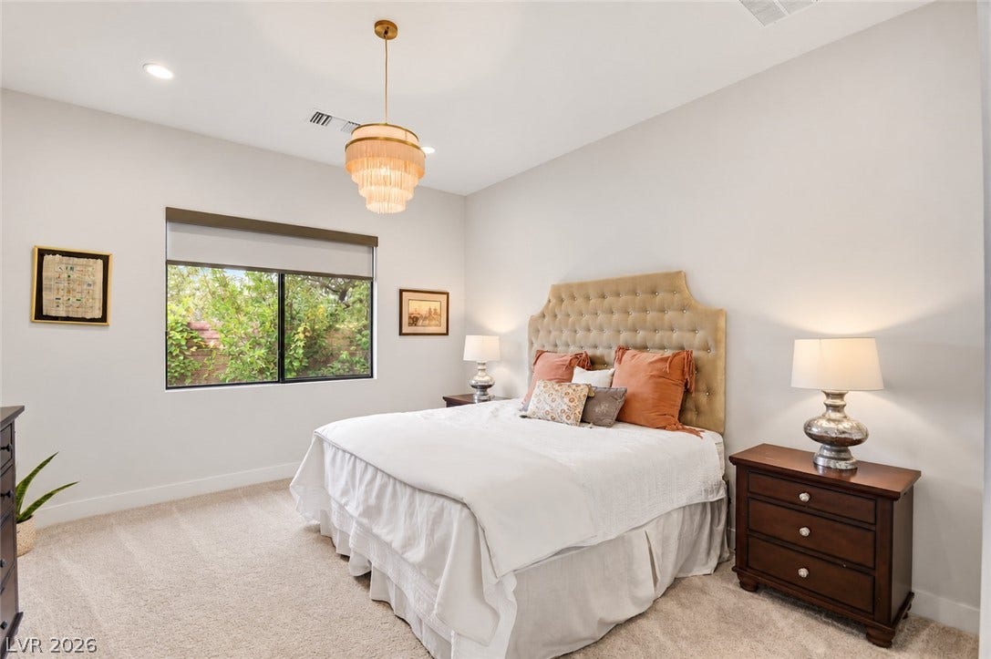 1 Moonfire Drive, Las Vegas, NV 89135 Plush carpeting and high ceilings define this inviting bedroom space.