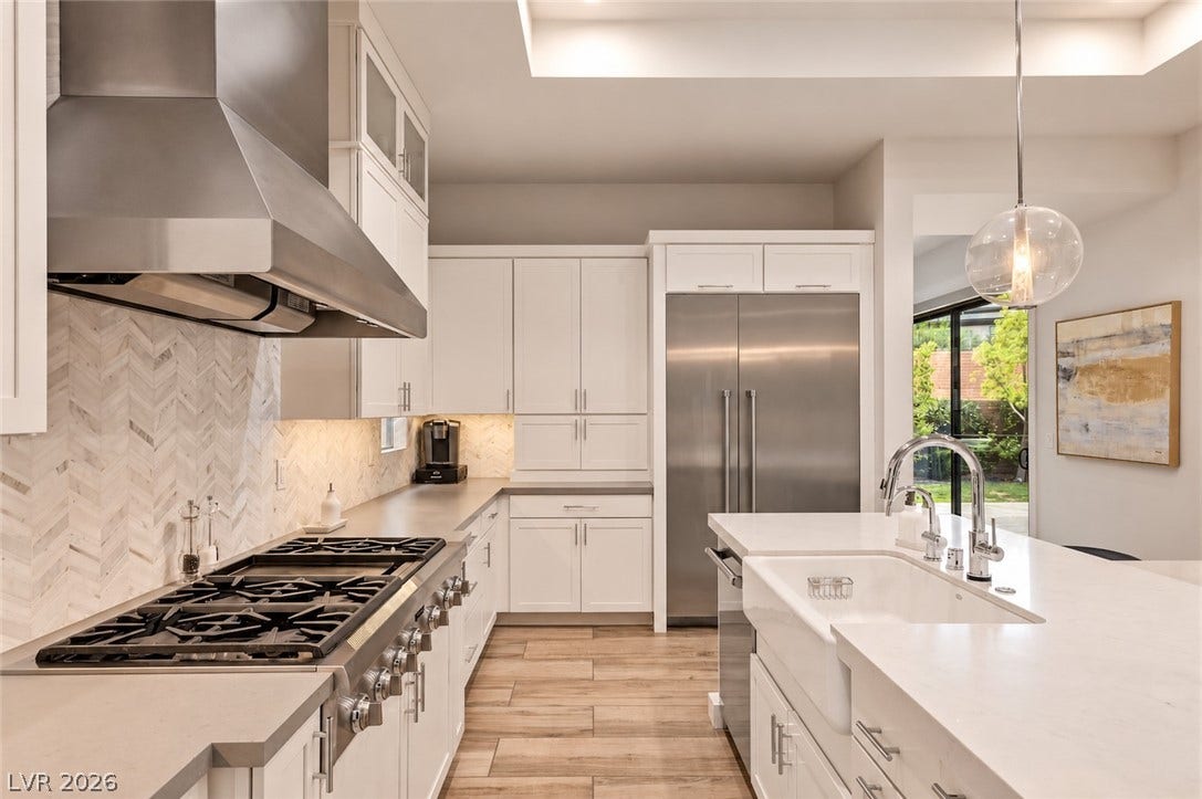 1 Moonfire Drive, Las Vegas, NV 89135 Modern cabinetry and professional-grade appliances anchor this light-filled gourmet space.