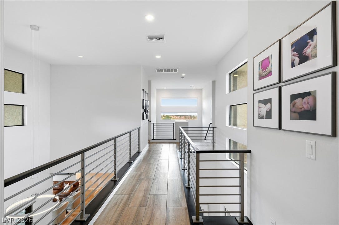 1 Moonfire Drive, Las Vegas, NV 89135 A sleek upper walkway features modern metal railings and handsome wood-look flooring.