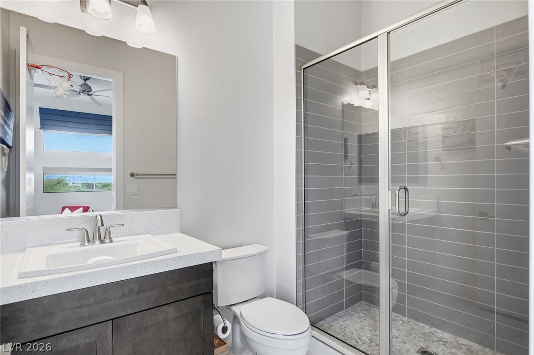 1 Moonfire Drive, Las Vegas, NV 89135 Modern stone counters and a glass-enclosed walk-in shower elevate this contemporary bathroom design.