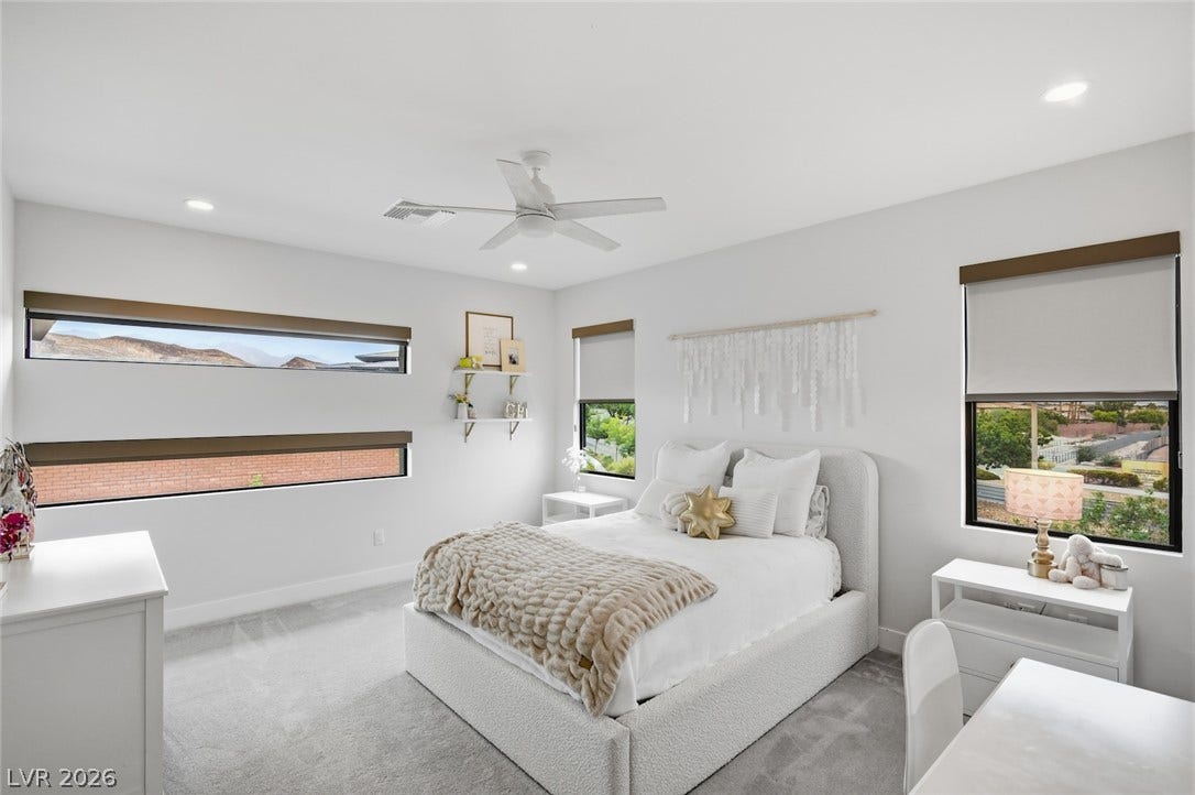 1 Moonfire Drive, Las Vegas, NV 89135 An abundance of natural light fills this modern bedroom with plush carpeting.