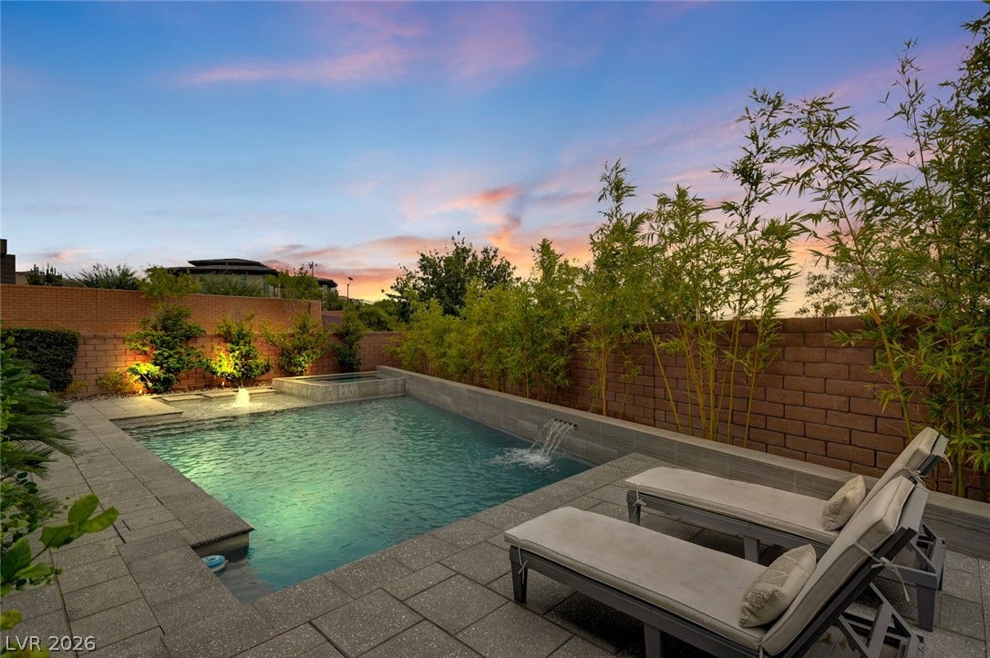 1 Moonfire Drive, Las Vegas, NV 89135 An inviting backyard oasis features a sparkling swimming pool, integrated spa, and elegant stone pavers.