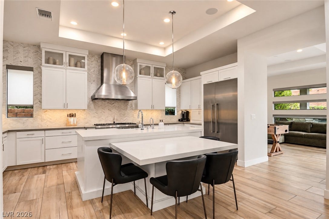 1 Moonfire Drive, Las Vegas, NV 89135 Premium stone countertops and high-end cabinetry anchor this modern culinary space.