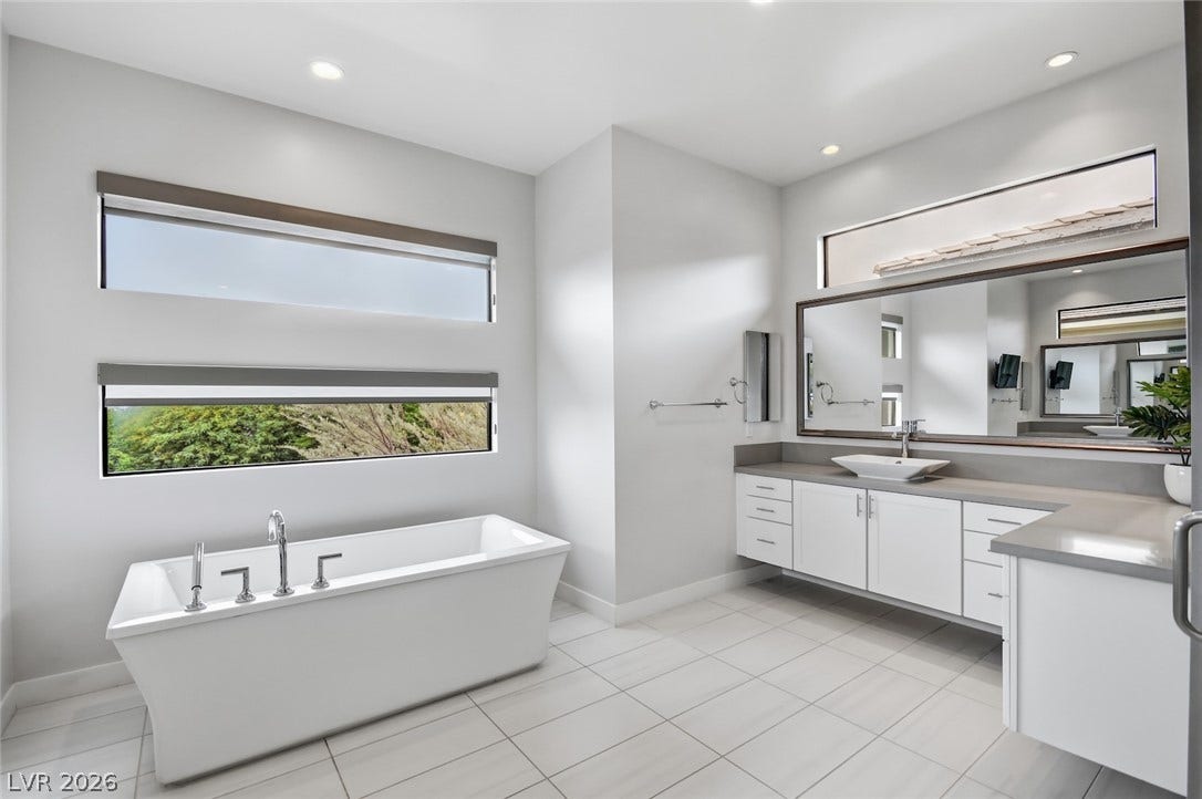 1 Moonfire Drive, Las Vegas, NV 89135 Clean lines and a freestanding tub define this modern bathroom retreat.