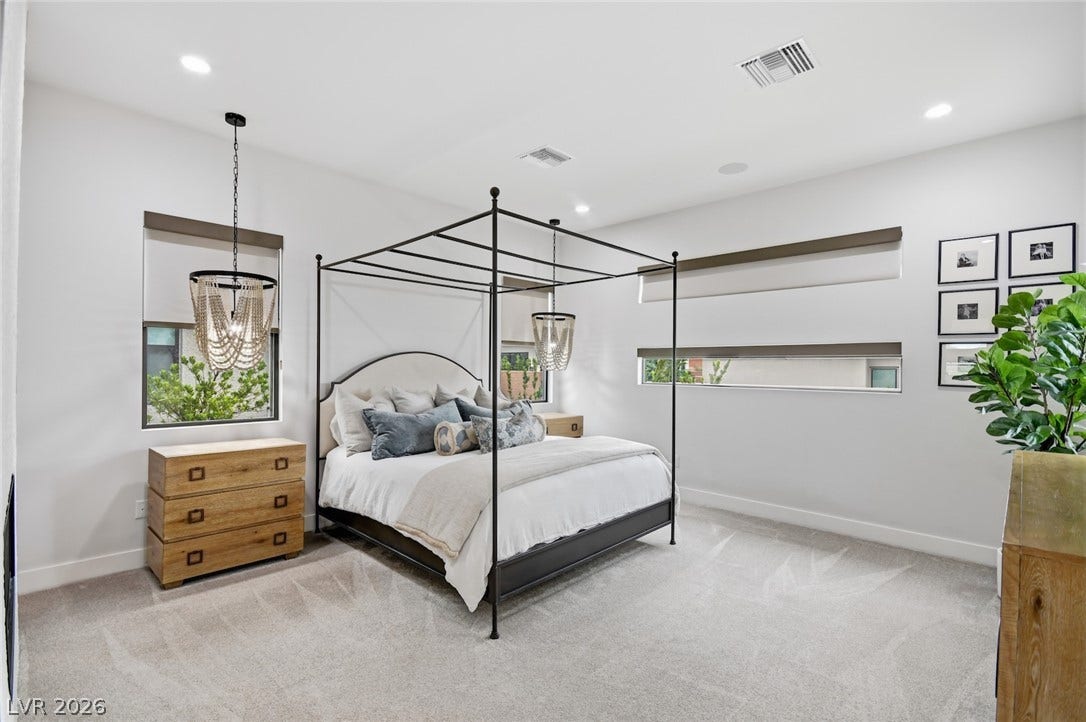 1 Moonfire Drive, Las Vegas, NV 89135 A spacious bedroom features neutral-toned carpet, recessed lighting, and modern horizontal windows.