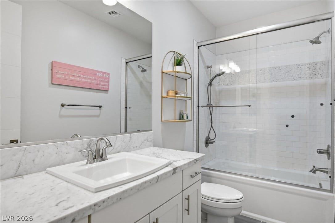 1 Moonfire Drive, Las Vegas, NV 89135 Gleaming stone countertops and a modern glass shower enclosure elevate this functional space.