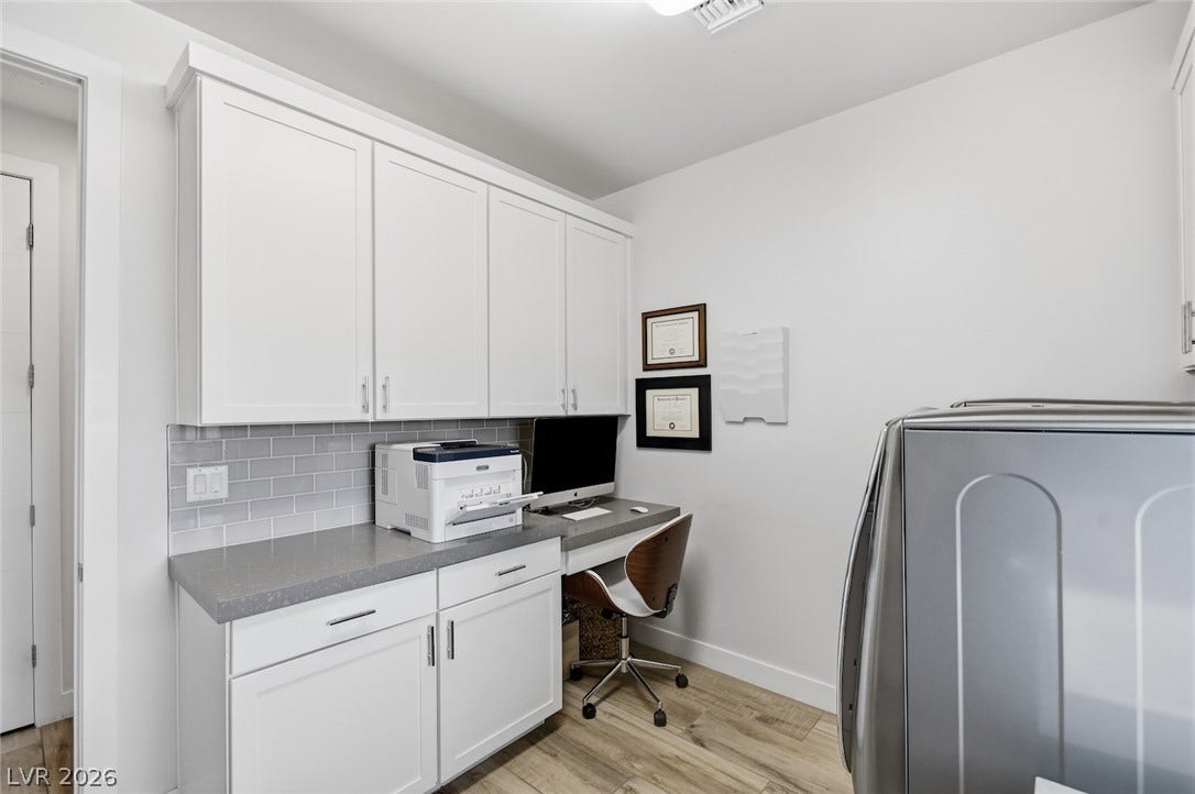 1 Moonfire Drive, Las Vegas, NV 89135 Ample built-in cabinetry and stone countertops anchor this functional workspace.