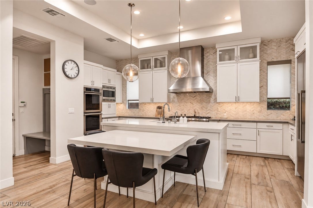 1 Moonfire Drive, Las Vegas, NV 89135 Gleaming stone countertops and a spacious central island anchor this contemporary culinary space.