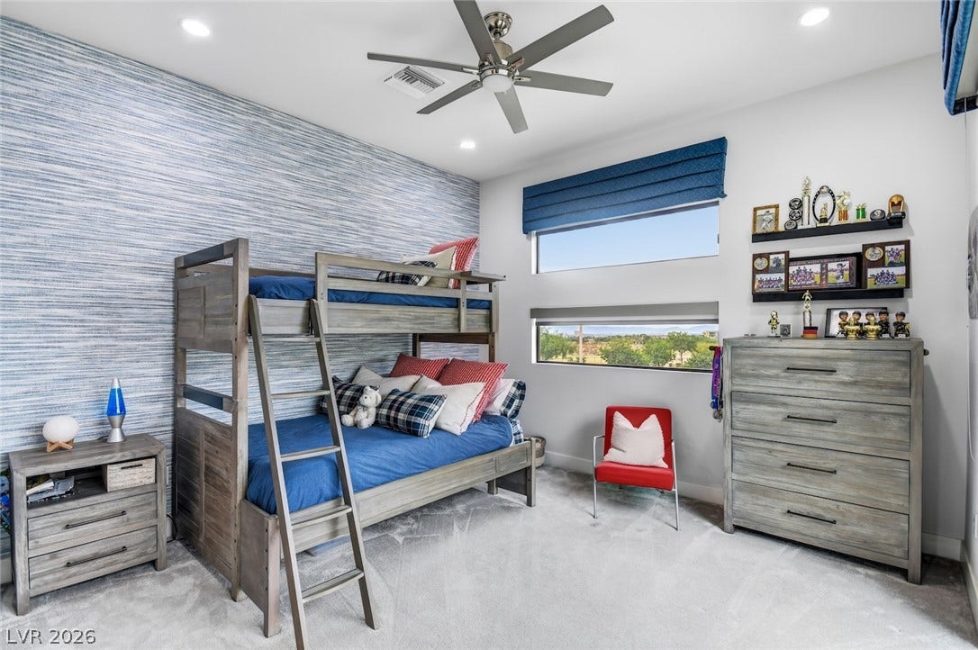 1 Moonfire Drive, Las Vegas, NV 89135 Natural light pours through dual horizontal windows, illuminating the plush carpeting and textured wall.