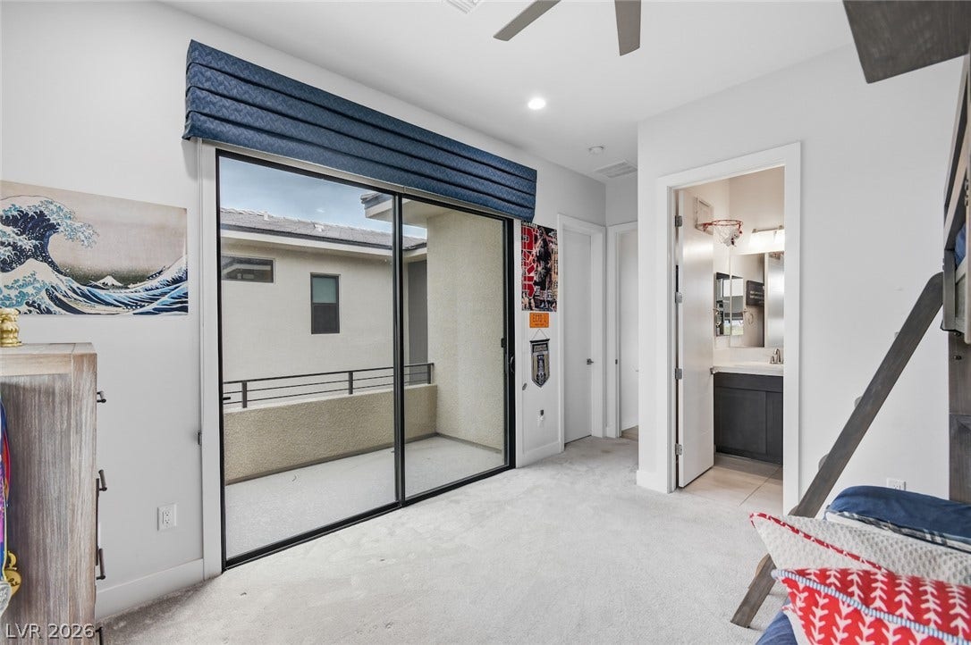 1 Moonfire Drive, Las Vegas, NV 89135 Sliding glass doors open directly to a private balcony from this spacious secondary suite.