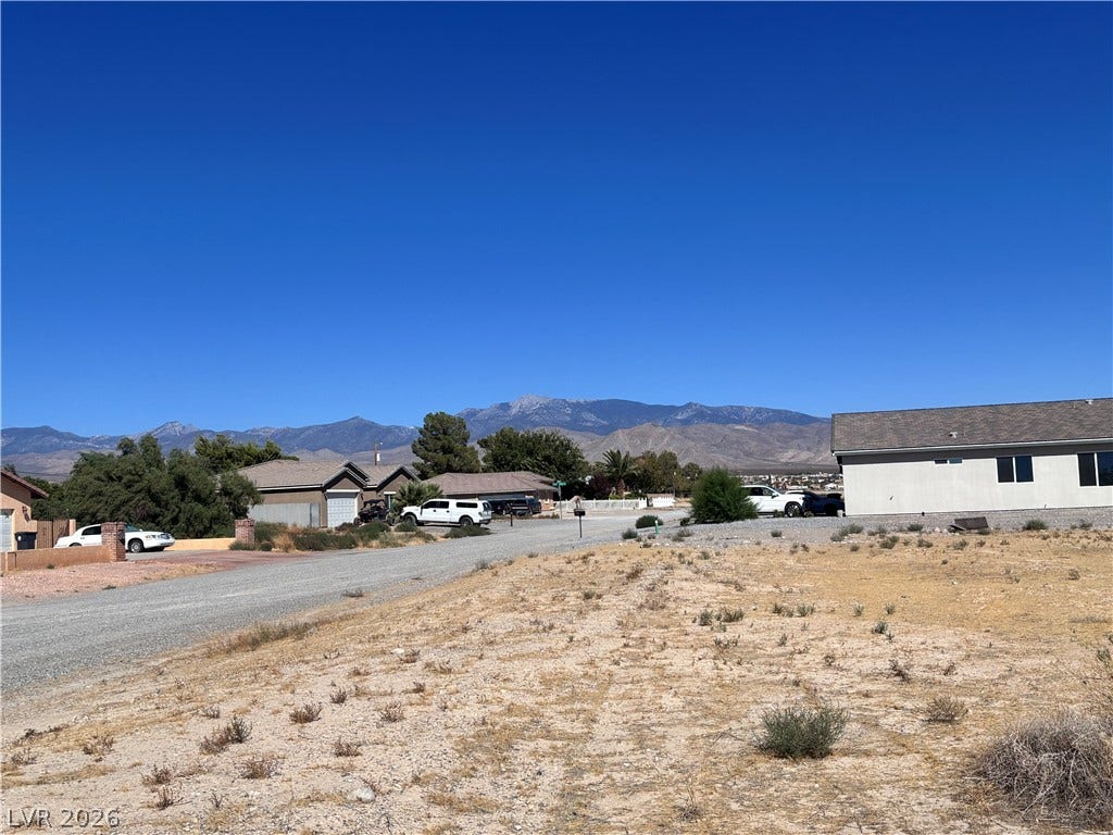 941 E Enchanted Mesa Street, Pahrump, NV 89048 Majestic mountain peaks form a scenic backdrop to this peaceful residential streetscape. Neighborhood to the East