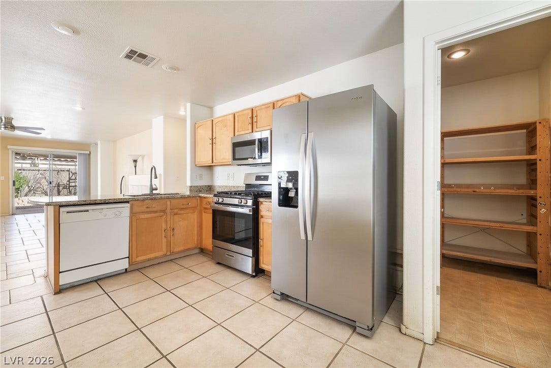 769 Salt Flats Circle, Henderson, NV 89011 An open kitchen layout transitions smoothly into nearby living areas over tile flooring.