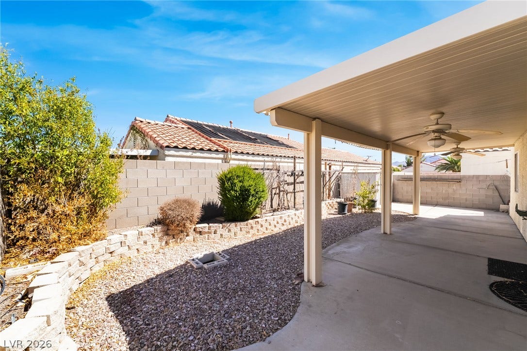 769 Salt Flats Circle, Henderson, NV 89011 A sheltered concrete patio overlooks a low-maintenance gravel yard with structured masonry retaining walls.