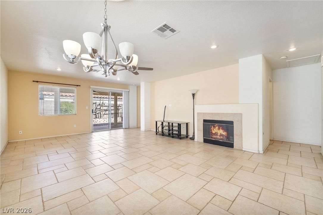 769 Salt Flats Circle, Henderson, NV 89011 Tiled flooring and a classic fireplace anchor this open living area.